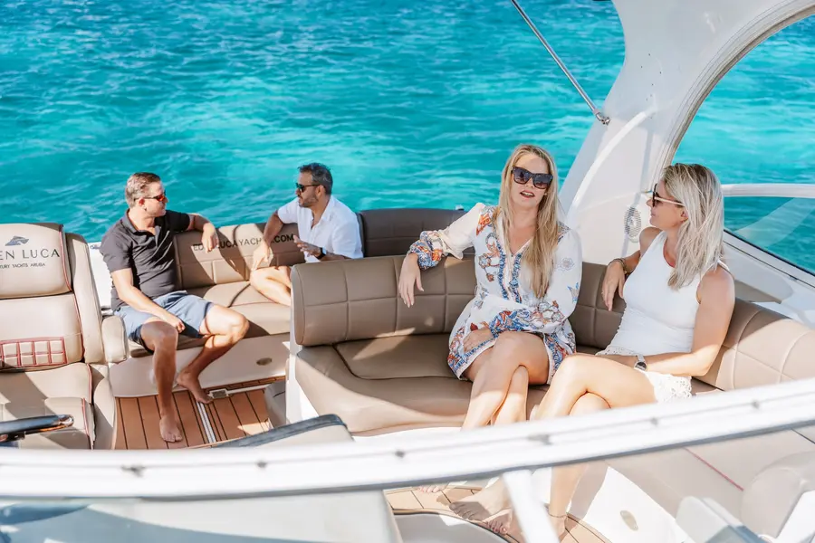 Friends cruising Aruba's coastline aboard an Eden Luca yacht