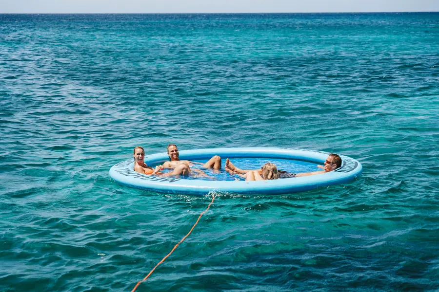 Sunchill floating lounge behind an Eden Luca yacht in Aruba