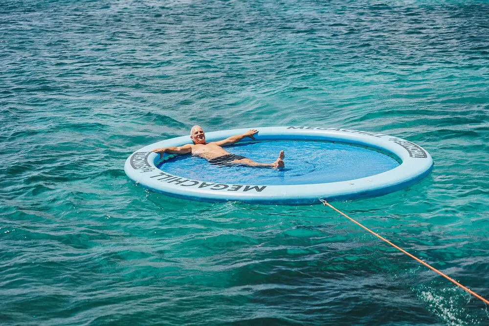 SunChill floating lounge behind an Eden Luca yacht in Aruba